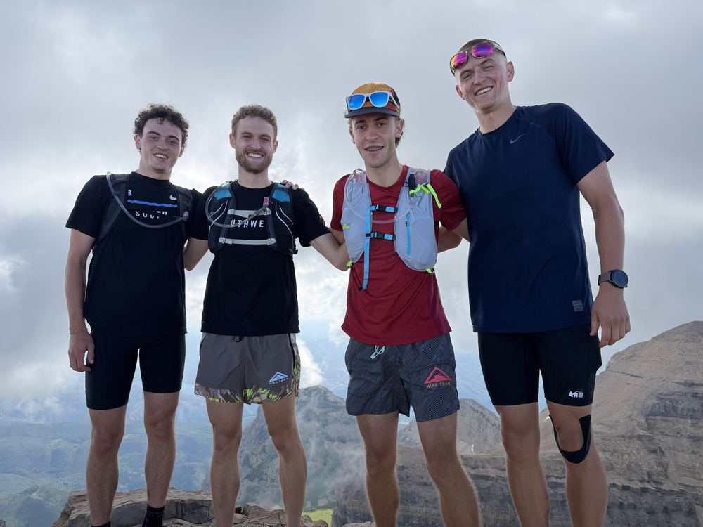 Standing on the summit of Mount Timpanogos with three friends after the hike